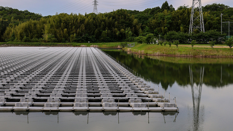 Solar panels floating over a pond