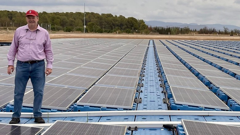 Man standing on floating solar panels