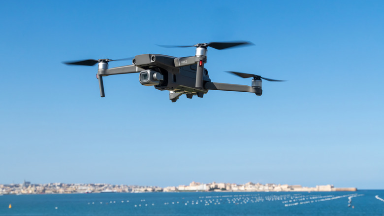 An automated drone flying over the ocean
