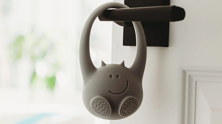 The Decco Toddler Monitor door sensor hanging on a door knob.