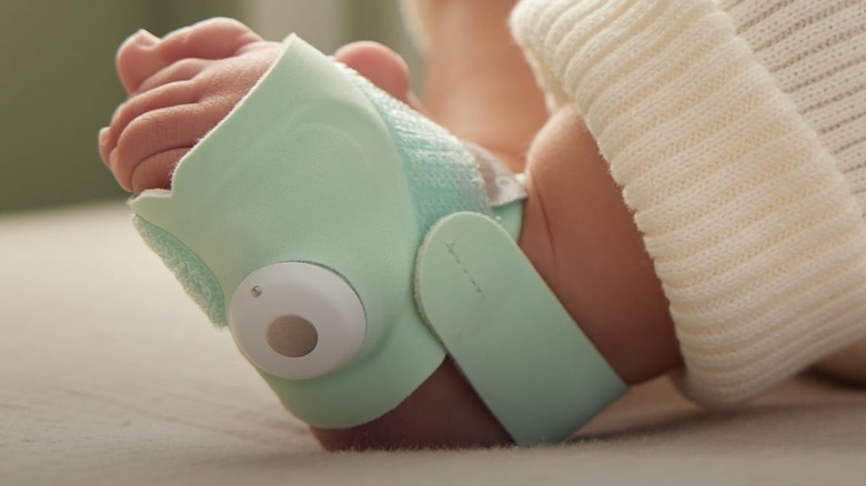 The Owlet Dream Sock smart sock on a baby's foot.