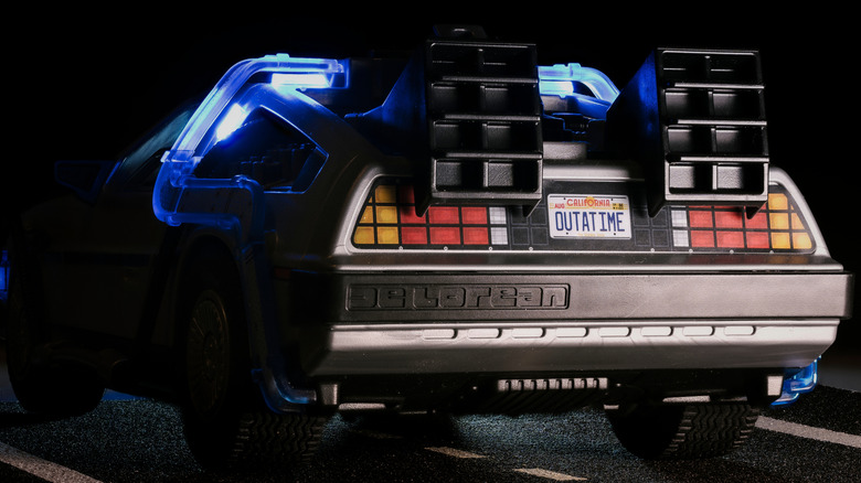 The rear end of a DeLorean that has been outfitted with Back to the Future-style accessories, including an 