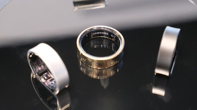 three samsung galaxy rings on a reflective surface