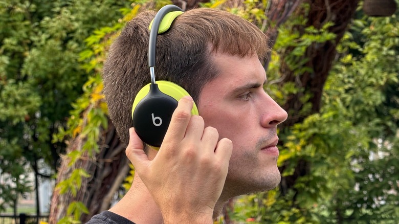 Man wearing Beats 360 headphones in an outdoor environment