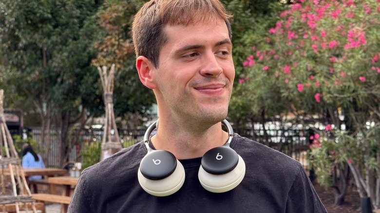 Man with Beats 360 headphones around his neck
