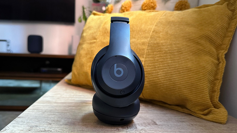 Beats Studio Pro on a bench with a yellow cushion behind it