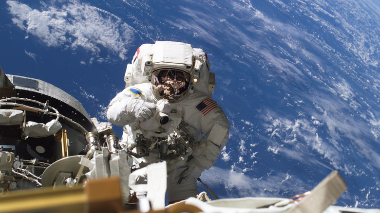 An astronaut seen on a space walk outside the International Space Station