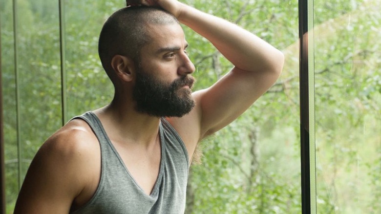 Nathan (Oscar Isaac) looking out a window in Ex Machina