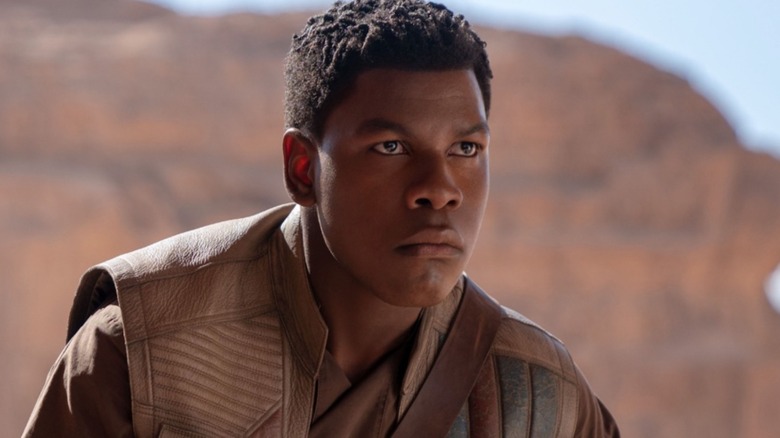 John Boyega as Finn stood against some cliffs
