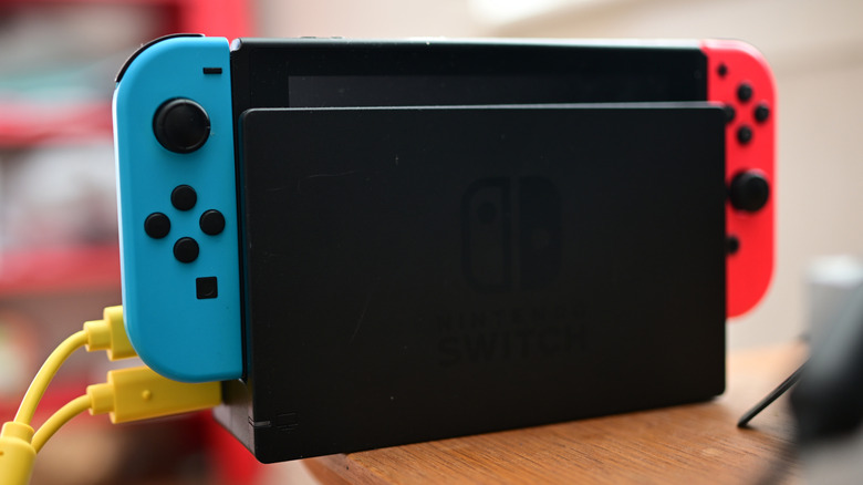 A Nintendo Switch 2 above stacked physical game