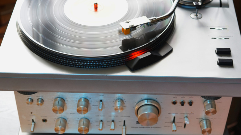A modern turntable on top of a receiver
