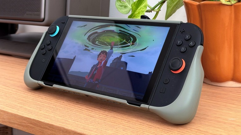 A Nintendo Switch 2 on a desk attached with Belkin's Charging Grip accessory