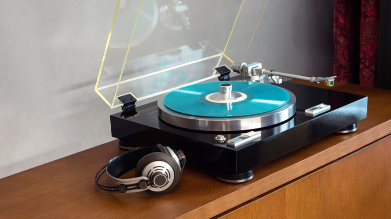 Image showing a vintage vinyl turntable with a blue record and a pair of headphones.