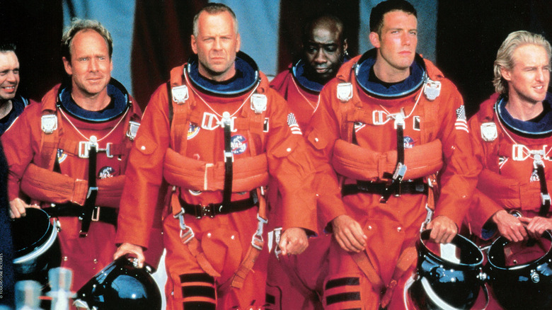 The drilling crew in space suits, walking together
