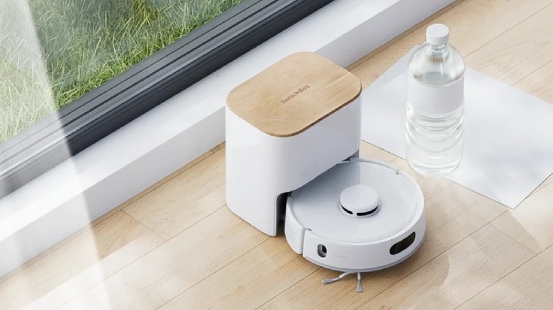 Switchbit K11+ in white on wooden floor by slider.