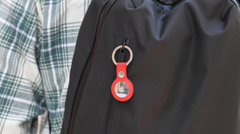 An AirTag attached to a backpack