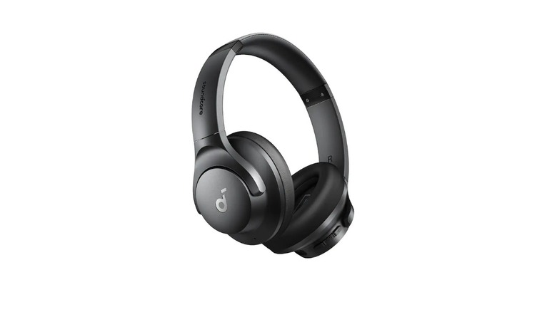 Man wearing over-ear headphones on a plane flight