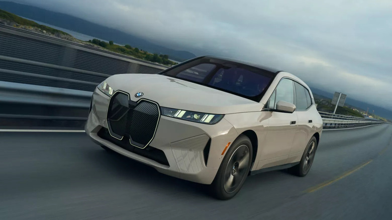 A 2026 BMW iX driving on a highway