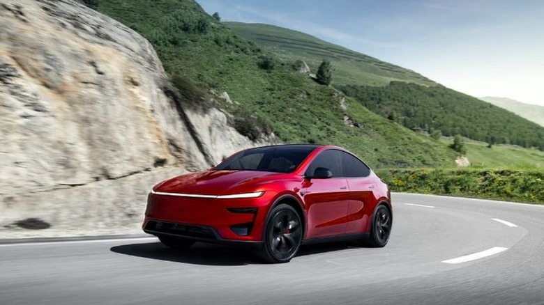2026 Tesla Model Y electric SUV driving on a winding road