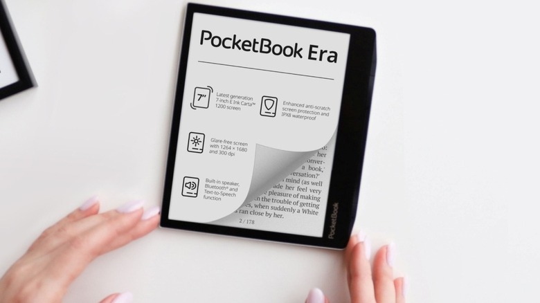 Fingers touching a PocketBook Era placed on a white surface
