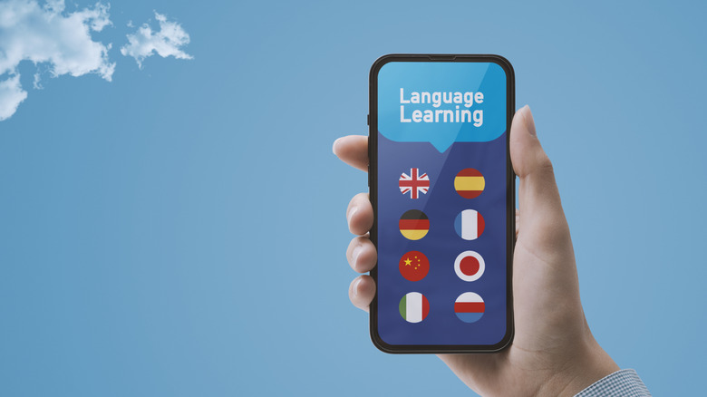 A language learning app on a smartphone, with a blue sky background.