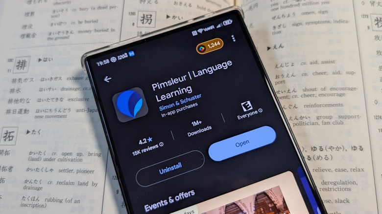 Pimsleur language learning app in front of a Japanese dictionary