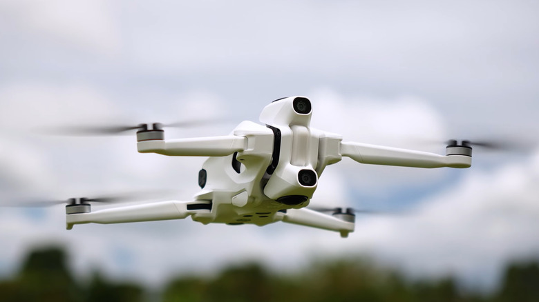 The Costco logo on the side of a store, lit up by floodlights.