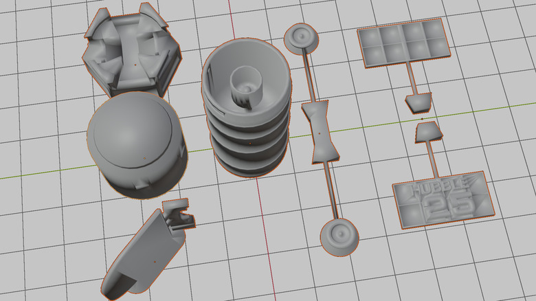 Parts of a printable model of the Hubble Telescope are visible on a virtual grid.