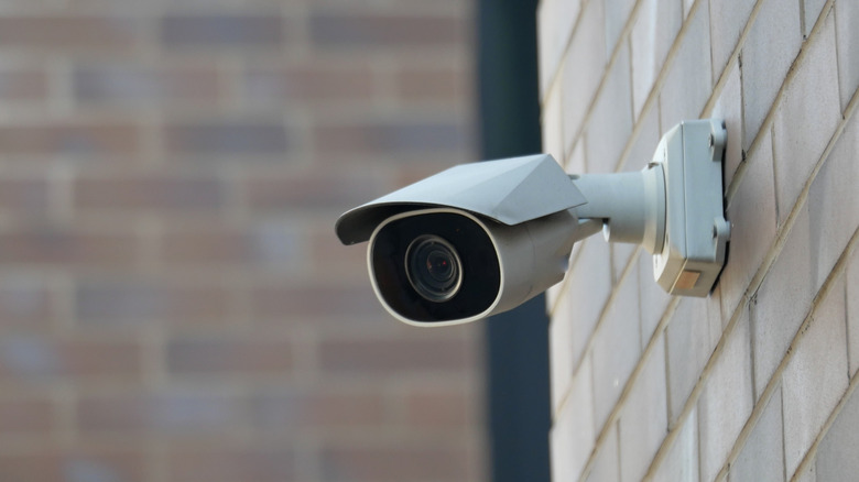 A security camera mounted on a brick wall