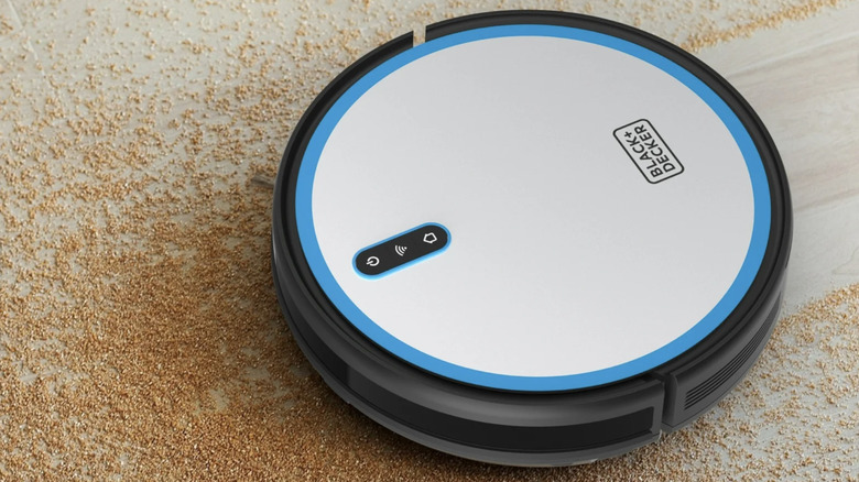 The BDRV1-SLV robot vacuum from Black+Decker clearing dust.