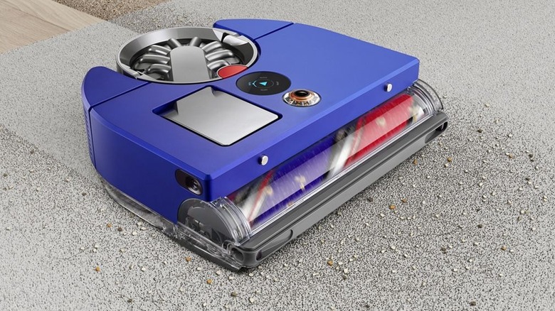 The Dyson 360 Vis Nav clearing up dust on a rug