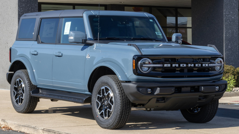 A grey 2025 Ford Mustang parked on a pavement