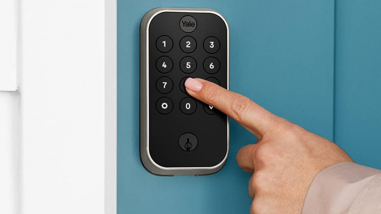 Pressing the touchpad of the Yale Assure Lock 2