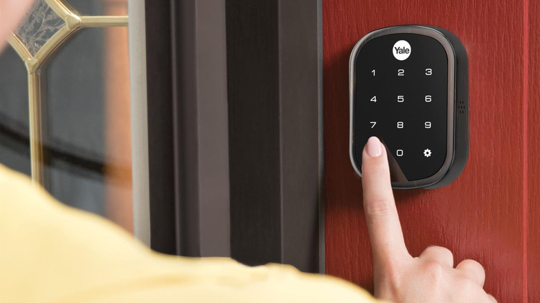 Pressing the touchpad of the Yale Assure Lock SL