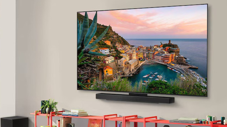 An LG C5 TV mounted on a wall, with a soundbar placed under it
