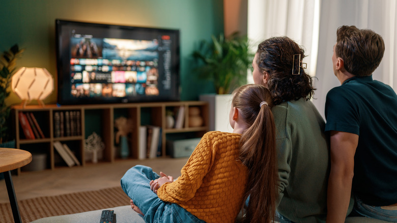 A family watching television together in the living room
