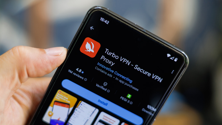 Man holding Google pixel showing Turbo VPN download page on Play Store