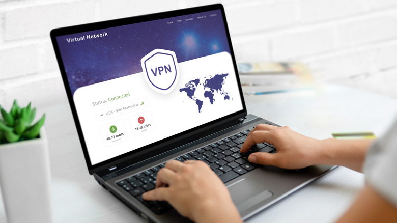 Person using a concept vpn showing world map on a laptop