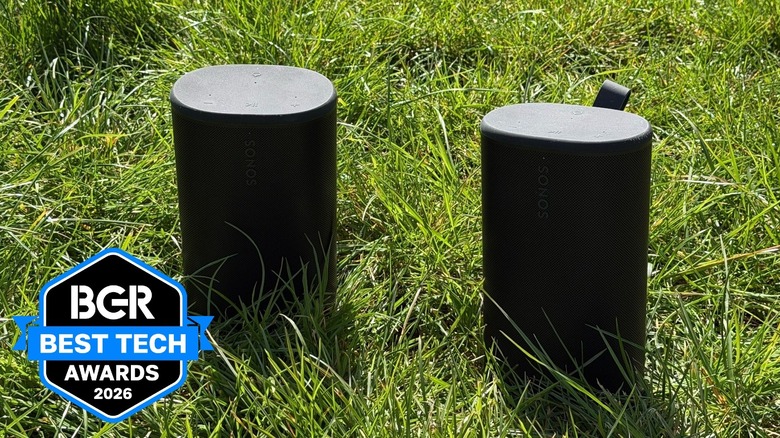 Sonos Play speakers sitting on a grassy field.