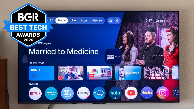 The Hisense UR8 TV mounted on a living room wall displaying Google TV.