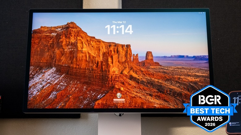 Apple Studio Display XDR on a desk next to an iPhone.