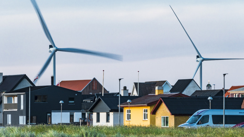 Wind turbines over a small city skyline