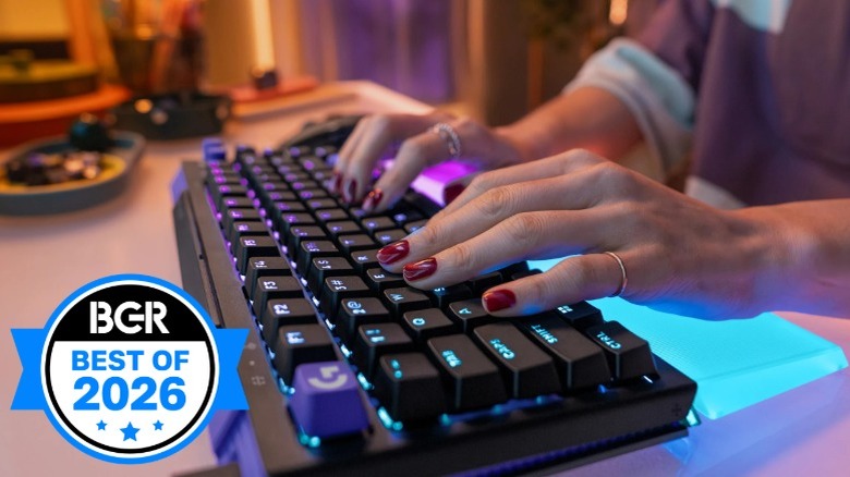 Person typing on the Logitech G512 X 75% keyboard with blue RGB on a desk