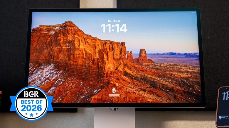 Apple Studio Display XDR on a desk next to an iPhone.
