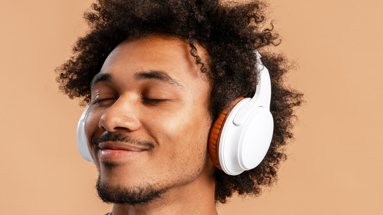 Person listening to headphones with eyes closed