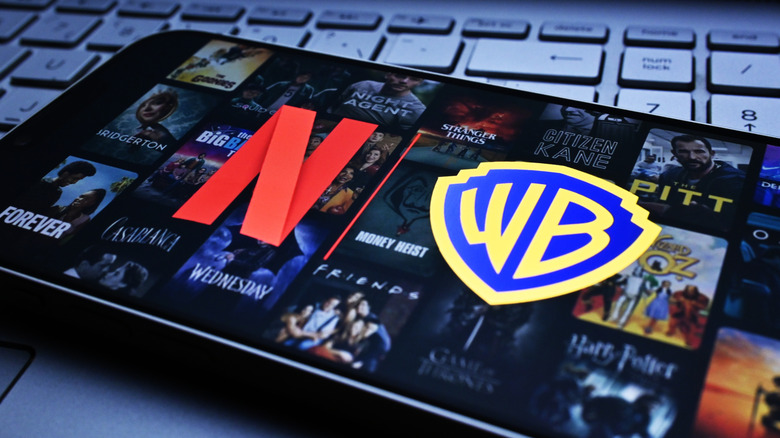Netflix and Warner Bros logos appear on the screen. Netflix and Warner Bros. are in talks regarding acquisition deals
