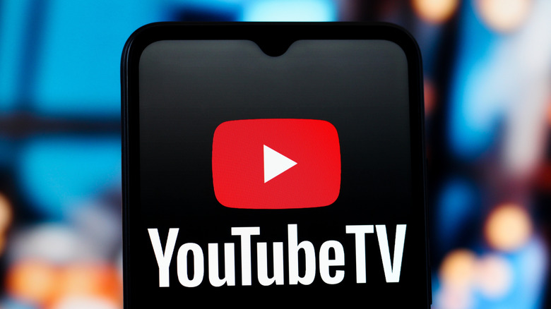 The YouTube TV logo is seen displayed on a smartphone screen