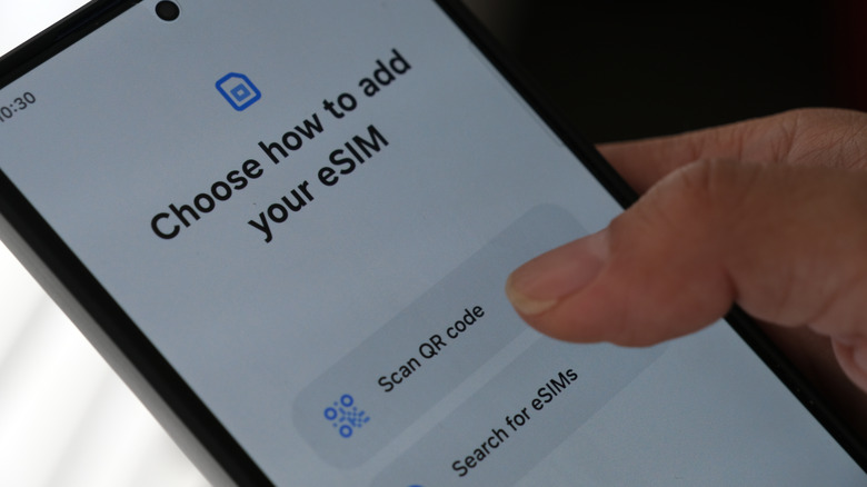 Person activating eSIM card on smartphone