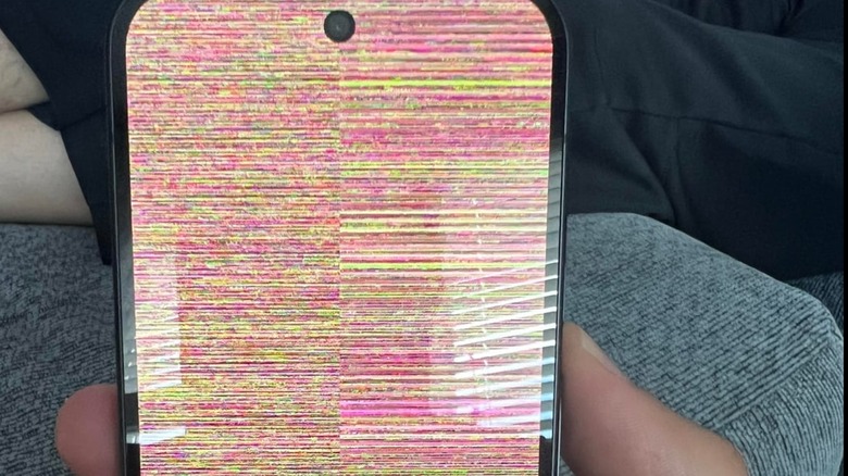 Google Pixel 10 smartphone screen glitching with rainbow snow