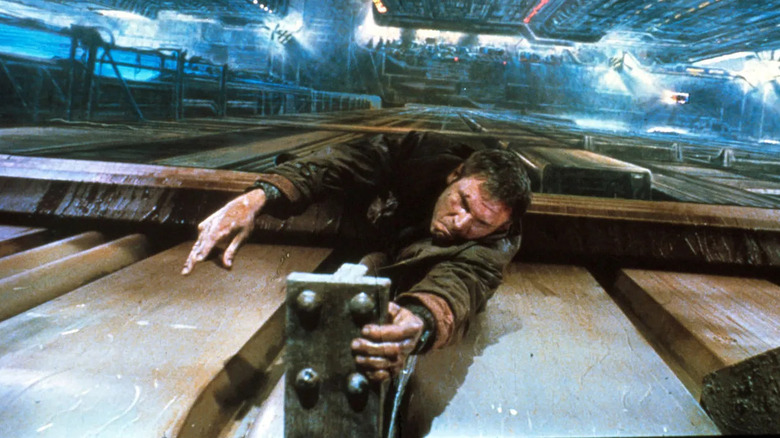 Rick Deckard hanging on a piece of metal in Blade Runner